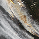 A satellite view shows thick smoke spreading over the landscape. Hot spots are visible below.